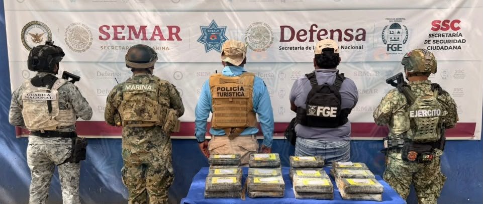 Packages of suspected cocaine laid out on a beach in Cancún's Hotel Zone after being seized by Tourist Police officers