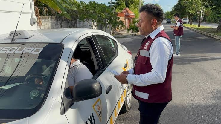 A taxi driver being checked by an official during an inspection in a residential area.$#$ CAPTION