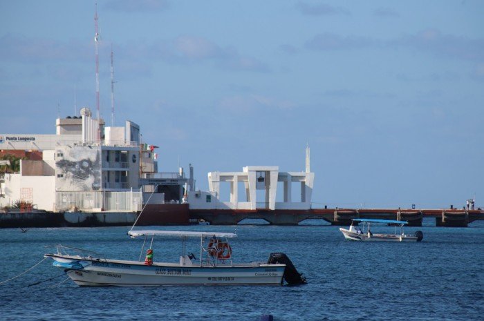 Tourist catamarans and passenger ferries moored at a dock in Quintana Roo