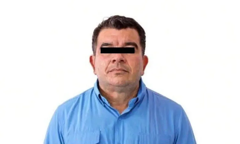Officials escort a suspect in the human trafficking investigation linked to Quintana Roo's former tourist police chief