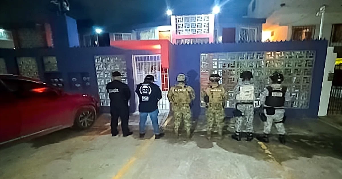 Police seal a property in Cancún after authorities rescued two women from human trafficking during two search warrants