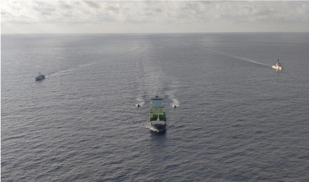 A Coast Guard vessel escorts the cargo ship Grace, seized for allegedly smuggling fuel to Cuba, toward the Mexican port of Progreso, Yucatán
