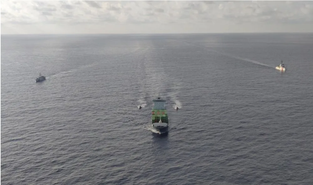 A Coast Guard vessel escorts the cargo ship Grace, seized for allegedly smuggling fuel to Cuba, toward the Mexican port of Progreso, Yucatán